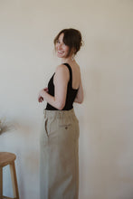 Load image into Gallery viewer, side view of model wearing the in another life skirt. model has the skirt paired with the used to know bodysuit in the color black.