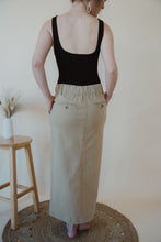Load image into Gallery viewer, back view of model wearing the in another life skirt. model has the skirt paired with the used to know bodysuit in the color black.