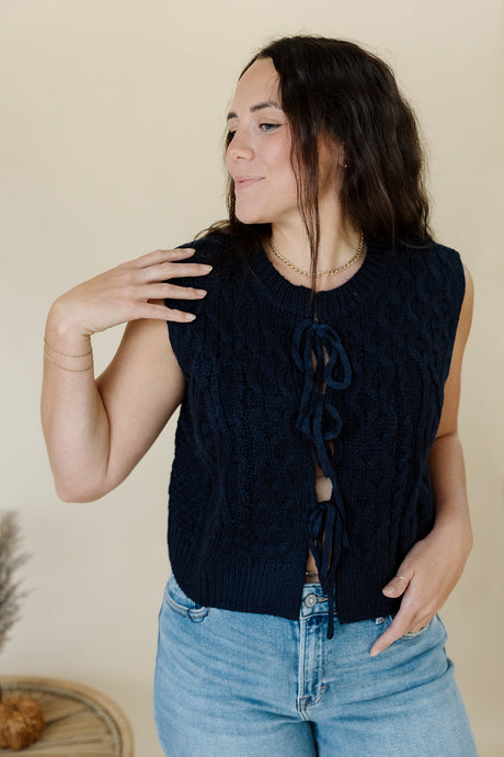 front view of model wearing the in season sweater tank. model has the sweater paired with a pair of medium wash denim.