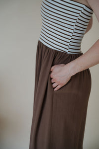 close up view of model wearing the feels like home maxi dress featuring a view of the side pockets.