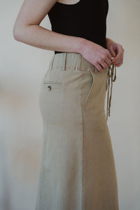 detail view of model wearing the in another life skirt. model has the skirt paired with the used to know bodysuit in the color black.