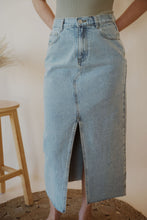 Load image into Gallery viewer, detail view of model wearing the as long as I live denim midi skirt. model has the skirt paired with the used to know bodysuit in the color light moss.