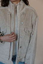 Load image into Gallery viewer, detail view of model wearing the these are the days jacket. model has the jacket paired with the until you top in the color cream.