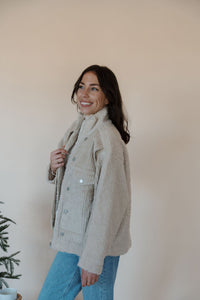 side view of model wearing the these are the days jacket. model has the jacket paired with the until you top in the color cream.