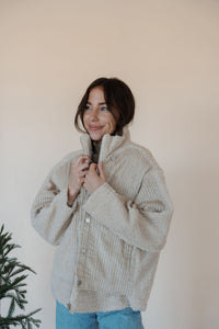 front view of model wearing the these are the days jacket. model has the jacket paired with the until you top in the color cream.