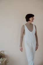 Load image into Gallery viewer, side view of model wearing the clara denim jumpsuit in denim.