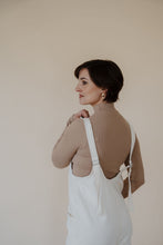 Load image into Gallery viewer, close side view of model wearing the clara denim jumpsuit in denim.