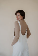 Load image into Gallery viewer, close back view of model wearing the clara denim jumpsuit in denim.