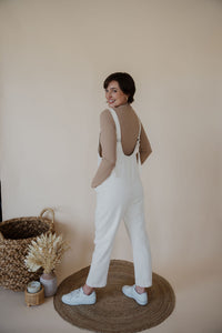 back view of model wearing the clara denim jumpsuit in denim.