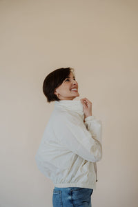 side view of model wearing the cherish the moment jacket in the color white dove. model has the jacket paired with the forever yours top in the color macchiato and the aurora denim.