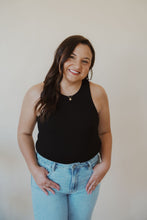 Load image into Gallery viewer, front view of model wearing the change your mind bodysuit in the color black. model has the bodysuit paired with the charleston denim.