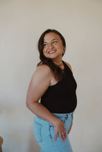 Load image into Gallery viewer, side view of model wearing the change your mind bodysuit in the color black. model has the bodysuit paired with the charleston denim.