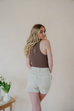 Load image into Gallery viewer, back view of model wearing the parker denim shorts. model has the shorts paired with the change your mind bodysuit in the color walnut and the dainty mallory necklace.