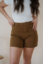 Load image into Gallery viewer, close detail view of model wearing the hayden denim shorts. model has the shorts paired with the take a chance bodysuit in the color off white and the anna necklace.