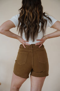 close back detail view of model wearing the hayden denim shorts. model has the shorts paired with the take a chance bodysuit in the color off white and the anna necklace.
