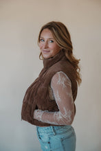 Load image into Gallery viewer, side view of model wearing the seems so simple puffer vest in the color cocoa. model has the vest paired with the here to stay top in the color cream and the charleston denim.