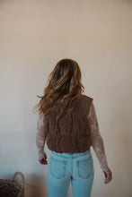 Load image into Gallery viewer, back view of model wearing the seems so simple puffer vest in the color cocoa. model has the vest paired with the here to stay top in the color cream and the charleston denim.