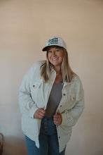 Load image into Gallery viewer, front view of model wearing the country and western trucker hat. model has the hat paired with the never be the same shacket and the change your mind bodysuit in the color smoky taupe.