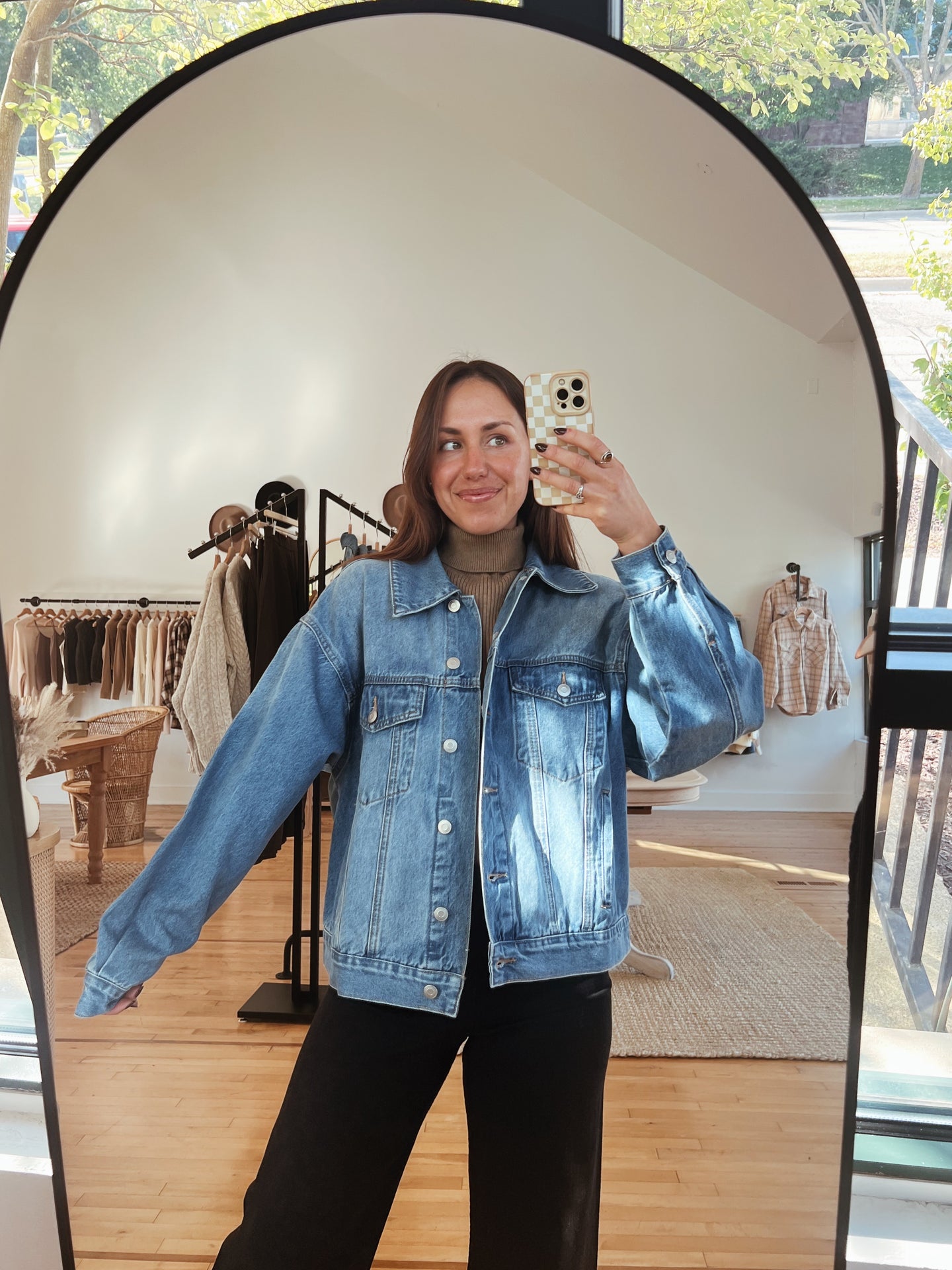 mirror selfie of model wearing the talk of the town jacket.