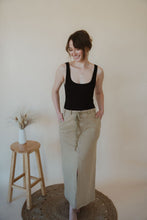 Load image into Gallery viewer, front view of model wearing the in another life skirt. model has the skirt paired with the used to know bodysuit in the color black.