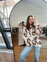 Load image into Gallery viewer, model wearing the out west sweater paired with the Jackson denim