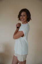 Load image into Gallery viewer, side view of model wearing the used to be set in the color cream/shell.