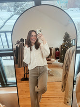 Load image into Gallery viewer, Model taking a mirror selfie wearing the never know sweater in cream and the addison denim.