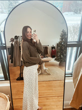 Load image into Gallery viewer, Model taking a mirror selfie wearing the never know sweater in brown and the bittersweet corduroy pants.