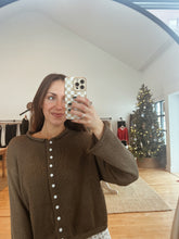 Load image into Gallery viewer, Model taking a mirror selfie wearing the never know sweater in brown and the bittersweet corduroy pants.