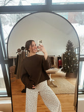 Load image into Gallery viewer, Model taking a mirror selfie wearing the destiny sweater in brown and the bittersweet corduroy pants.