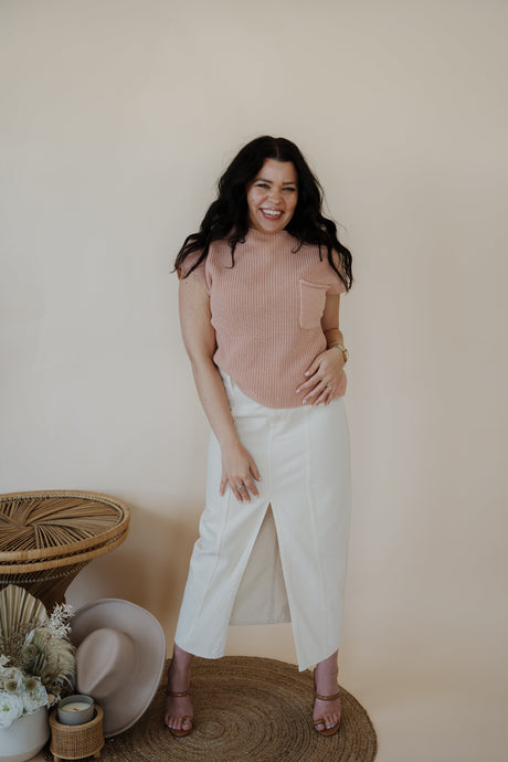 front view of model wearing the all over again denim midi skirt. model has the skirt paired with the nothing to prove top in the color dusty pink.