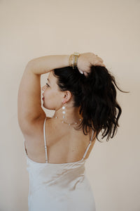 close up back view of model wearing the wherever I'm with you maxi. model has the dress paired with the MK necklace and the magnolia earrings.