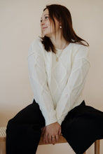 Load image into Gallery viewer, front view of model wearing the Addison denim in the color fade black. model has the denim paired with the somewhere in the middle sweater in the color white.