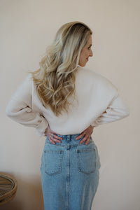 back view of model wearing the as long as I live denim midi skirt. model has the skirt paired with the halfway there top.