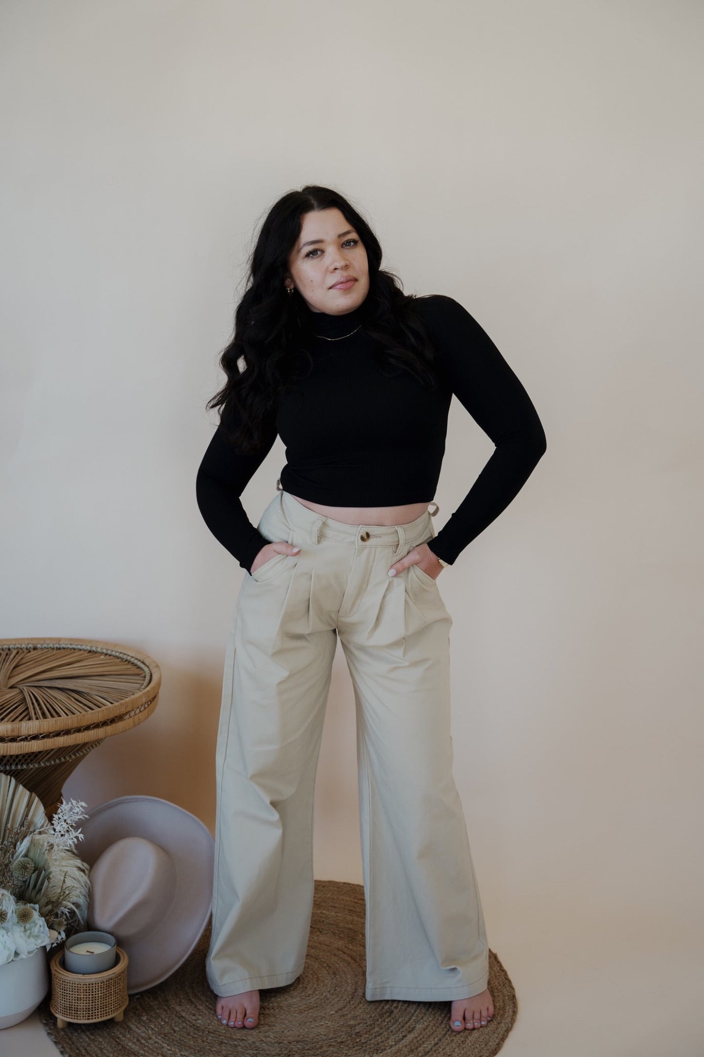 front view of model wearing the Oakland chinos. model has the chinos paired with the after all top in the color black.