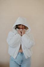 Load image into Gallery viewer, front view of model wearing the where it all began puffer in the color ivory. model has the puffer paired with the all along top in the color almond and the camden denim.