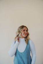 Load image into Gallery viewer, close front view of model wearing the clara denim jumpsuit in denim.
