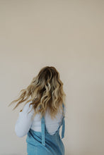Load image into Gallery viewer, back view of model wearing the clara denim jumpsuit in denim.