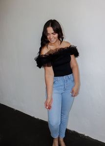 model wearing the crazy in love bodysuit in the color black. model has the top paired with a pair of light wash denim.