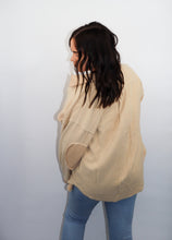 Load image into Gallery viewer, model wearing the until then jacket. model has the jacket paired with a pair of denim, has her back turned to the camera, and is looking downward.