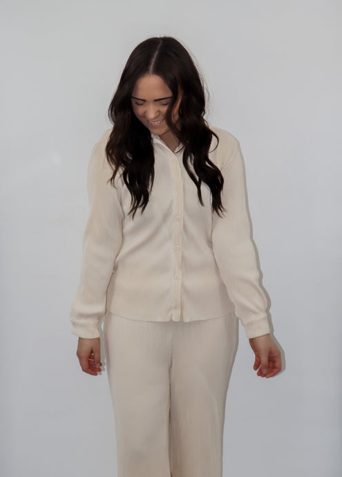 model wearing the aspen top + aspen pants in the color cream.