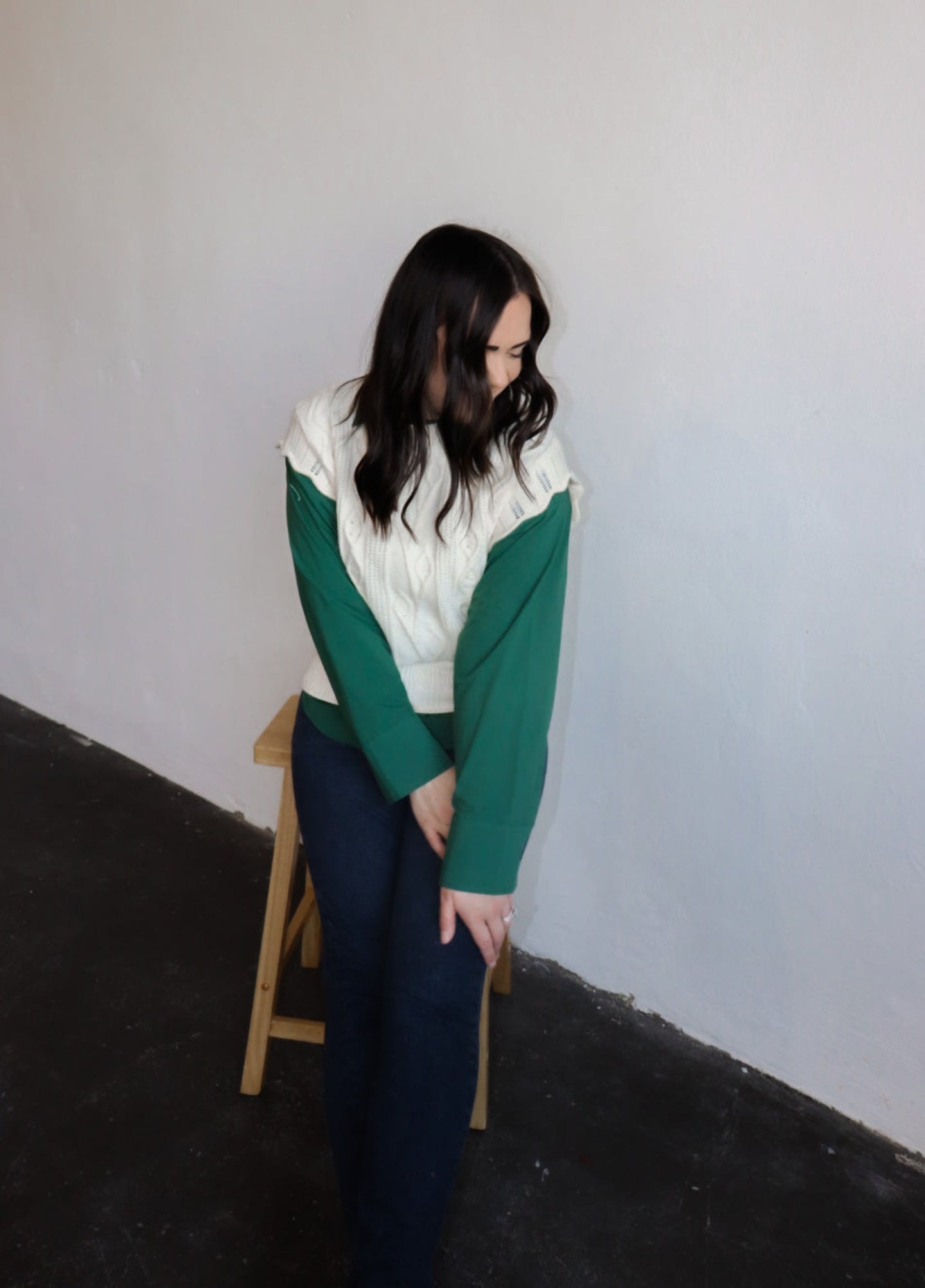 model wearing the all my days sweater vest paired with the take me away top in the color deep green. model has the tops paired with the siena denim.